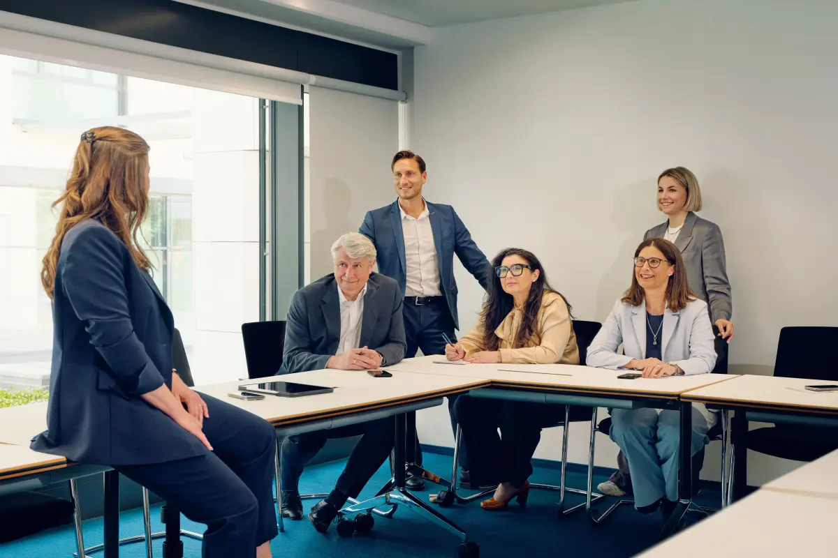 Gruppe aus Männern und Frauen verschiedenen Alters in Besprechungssituation